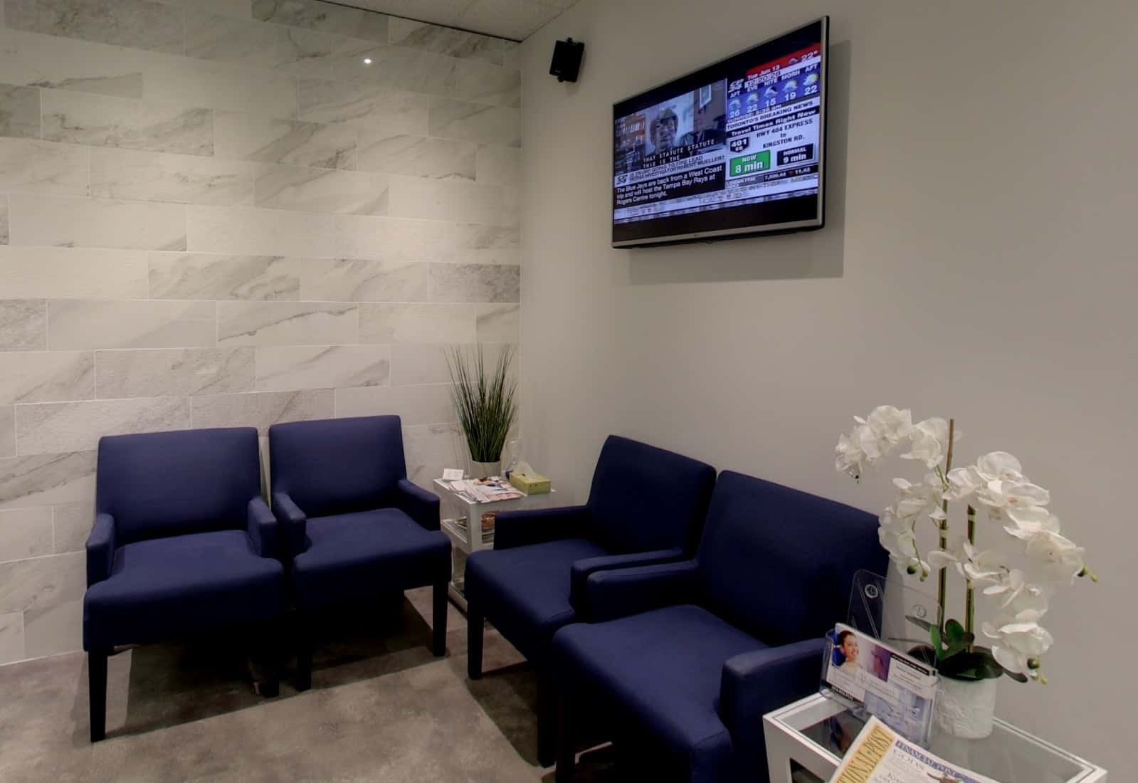 Dental office waiting area with flat screen television.