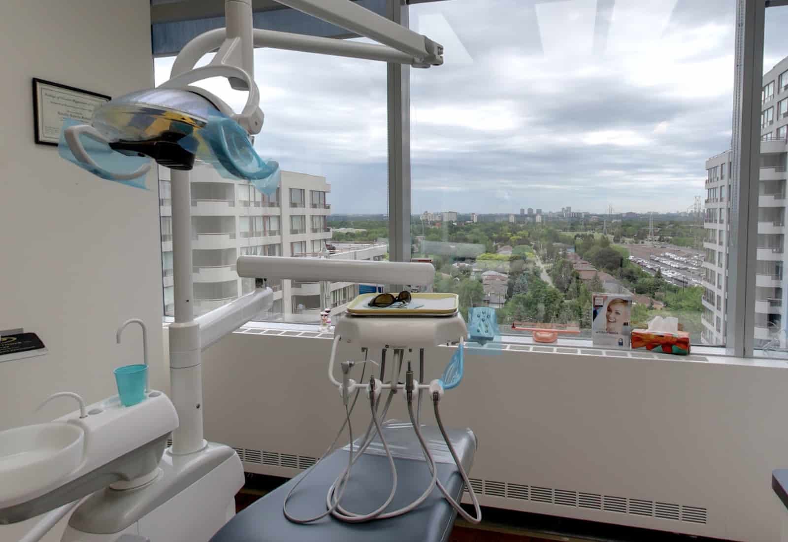 Dentist's chair inside clinic overlooking outdoor scenery.