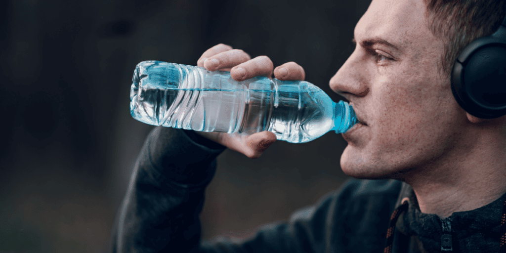 Man drinking water after teeth whitening procedure